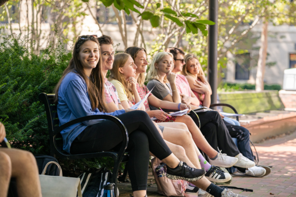 Liberal Arts students sit on a bench outside Willard Building
