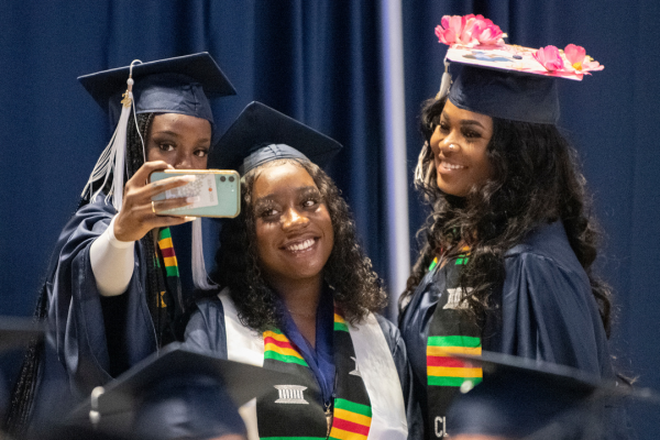 Three students take a selfie at the Liberal Arts Commencement Ceremony