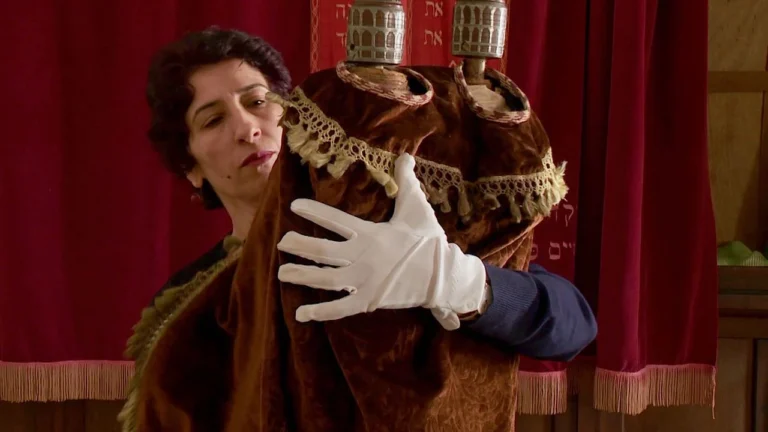 Photo of Zhor Rehihil holding a museum item.